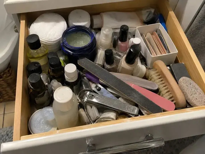 A bathroom drawer full of half-used nail treatments