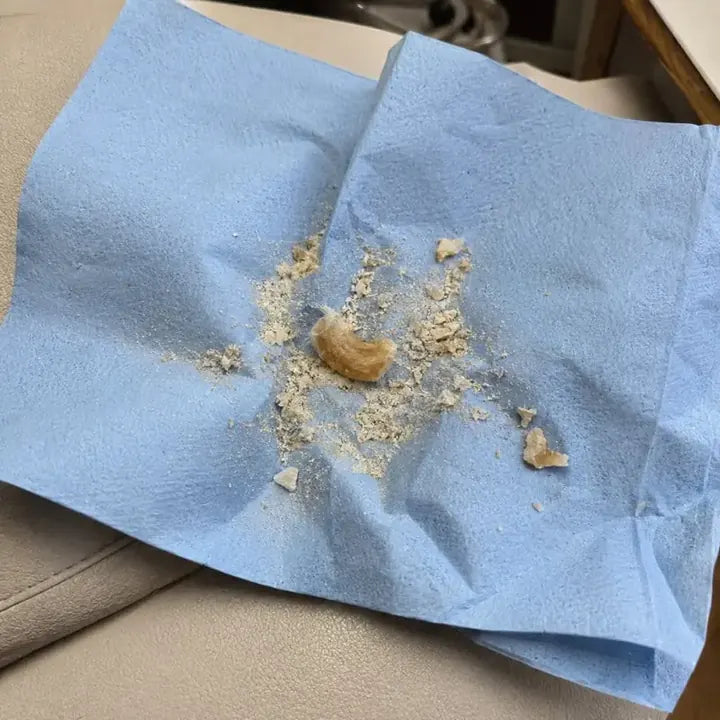 Pale nail dust on a blue paper towel